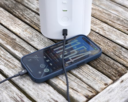 An iPhone 17 Pro charging from a Sonos Play speaker using a USB-C cable.
