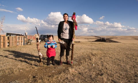 Tressa Welch, 26, and her daughter Kodi Monique stand on the plains outside Wolf Peck on the Fort Peck Indian Reservation in Montana.