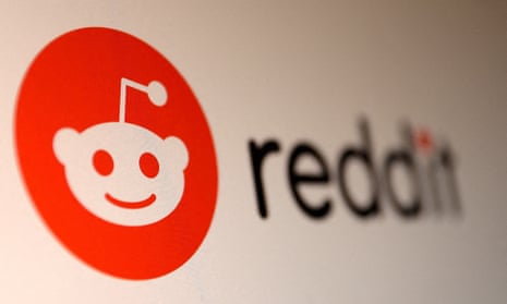 A photo of a Reddit logo on a screen.