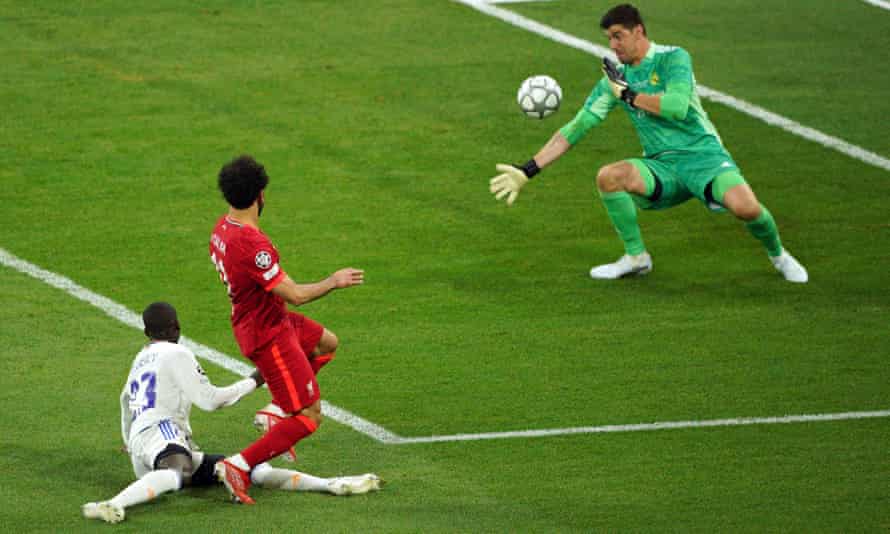 Real Madrid keeper Thibaut Courtois saves from Liverpool’s Mohamed Salah.
