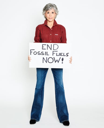Photograph of Jane Fonda holding a placard saying: End Fossil Fuels Now!