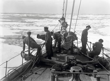Sailors look out to see from the ship’s bow