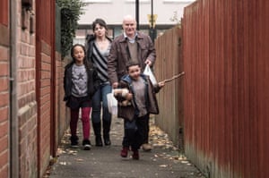Still from Ken Loach's 2016 film I, Daniel Blake, showing Briana Shann, Hayley Squires, Dave Johns, Dylan McKiernan