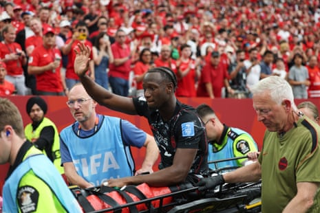 Ismael Kone sitting up and waving to the fans.