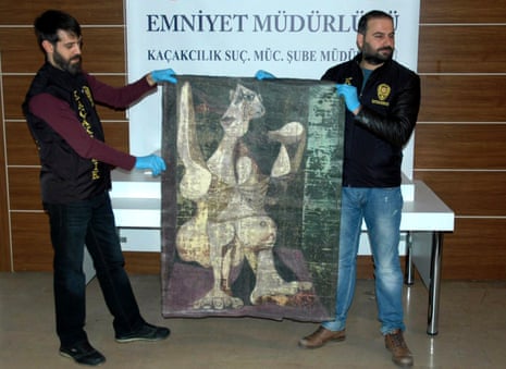 Turkish police in Istanbul hold-up an original painting by Pablo Picasso, Woman Dressing Her Hair, which they recovered on Saturday.