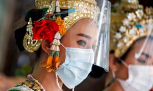 Thai dancers wear face mask and face shield as country reports another 2,940 new coronavirus cases and 30 deaths.