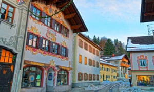 Cozy street with different colours of painted facades of the houses in Garmisch-Partenkirchen