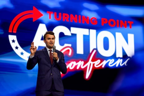 a man speaks in front of a background that reads "turning point action conference"
