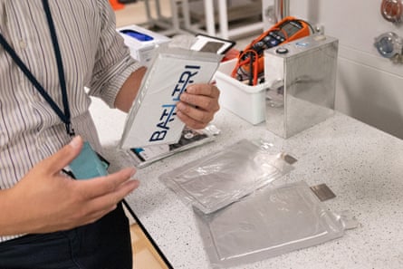 Dr Tim Khoo shows the finished batteries in the Deakin University research laboratory.