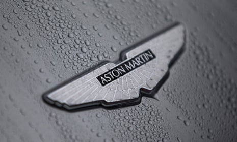 Aston Martin also reported a cut in sales and profit forecasts for the year.