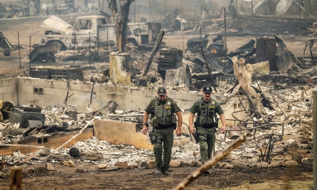 Sheriff's deputies leave a home where a McKinney fire victim was found on Monday, in Klamath National Forest, California.