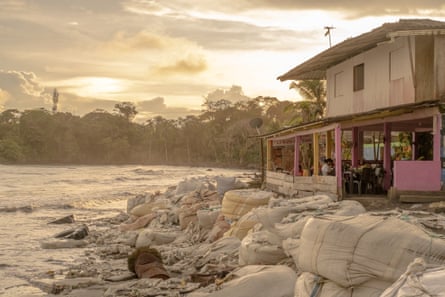 Large sandbags in front of a house on a beach