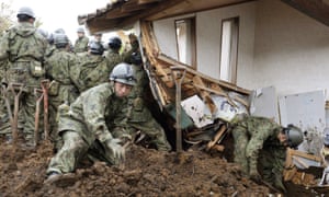 Members of Japan’s Self-Defence Force search on Monday for missing people after a landslide in Minamiaso.