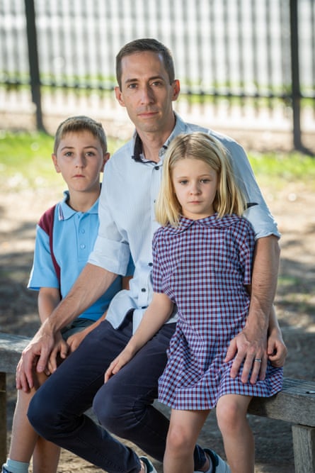 man sitting with son and daughter either side