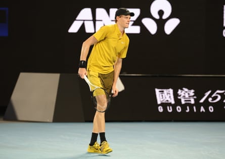 Jannik Sinner stretches his leg during a third round match against Eliot Spizzirri at the Australian Open