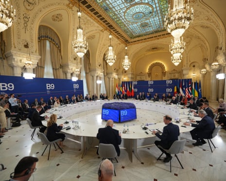 General view shows the participants sitting around a table at the start of the summit of the Bucharest Nine (B9) and the Nordic countries at the Cotroceni Palace in Bucharest, Romania.