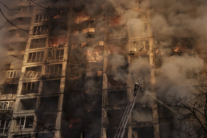 Ukrainian firefighters work at an apartment building after bombing in Kyiv.