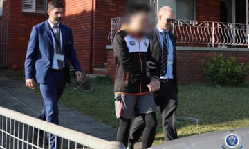 A supplied image obtained on Saturday, May 18, 2024, of NSW strike force detectives arresting a man in Old Guildford, Sydney on Friday May 17.