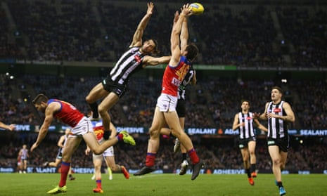 Oscar McInerney of the Lions and Brodie Grundy of the Magpies compete for the ball. 