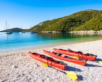 Red kayaks on a mediterranean beach