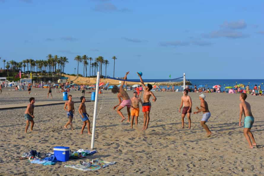 Group of young men playing beach volleyball on the Arenal Beach in Jávea on the Costa Blanca
