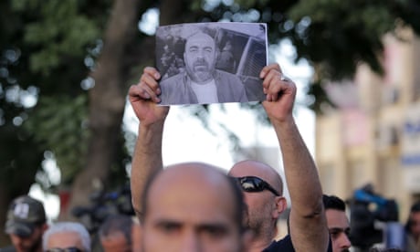 Palestinians take part in a protest aganist the death of Nizar Banat in the West Bank city of Ramallah on Sunday