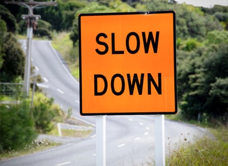 A road sign reading ‘slow down’