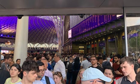 Rail passengers wait at King’s Cross, London, after a power outage disrupted train services.