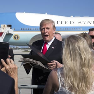 President Donald Trump greets people on the tarmac as he arrives on Air Force One at Palm Beach International Airport, in West Palm Beach, Flordia