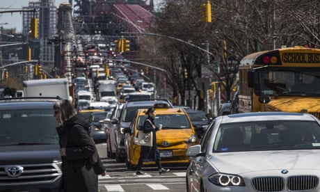 Pedestrians cross Delancey Street as congested traffic from Brooklyn enters Manhattan over the Williamsburg Bridge.
