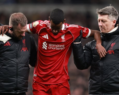 Alexander Isak is helped off the field by Liverpool’s medical staff.