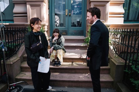 Celine Song (left) with Dakota Johnson and Chris Evans on the set of Materialists.
