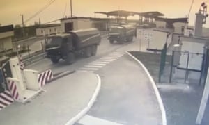 In this image made from video provided by the Border Service of Ukraine, military vehicles pass a control point at the Armyansk checkpoint at the Ukraine-Crimea border