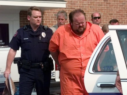 Officials escort Alan Miller away from the Pelham city jail in Alabama in 1995.