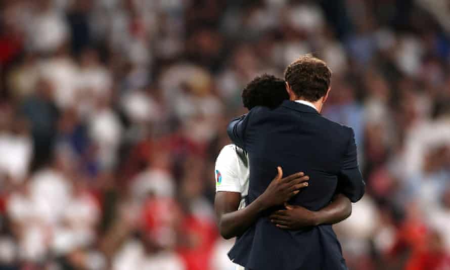 England manager Gareth Southgate comforts Bukayo Saka after losing the Euro 2020 final against Italy in July 2021.