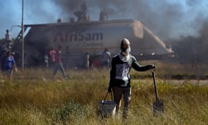 People loot cement from a truck during protests in Mahikeng, North West province. 3500.jpg?w=300&q=55&auto=format&usm=12&f