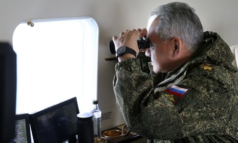 Russian defence minister, Sergei Shoigu, watches troops from onboard a military helicopter in Crimea.