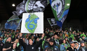 Seattle Sounders FC fans cheer before an MLS game. soccer has exploded in the city, and attendance at Sounders games averages 40,000.