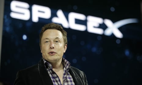 Elon Musk with a SpaceX logo behind