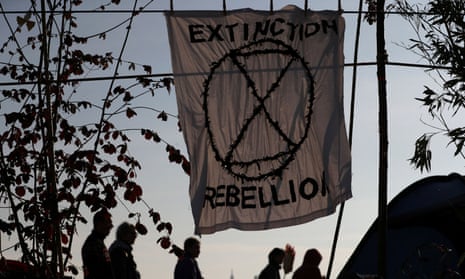 Extinction Rebellion banner and silhouetted figures
