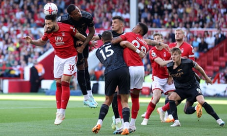 Felipe of Nottingham Forest jumps for the ball with Gabriel of Arsenal.