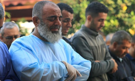 A Palestinian men cries while praying over the bodies of members of the Abu Taim family prior to them being taken for burial from the al-Nasser hospital in Khan Yunis in the southern Gaza Strip on 9 November 2023.