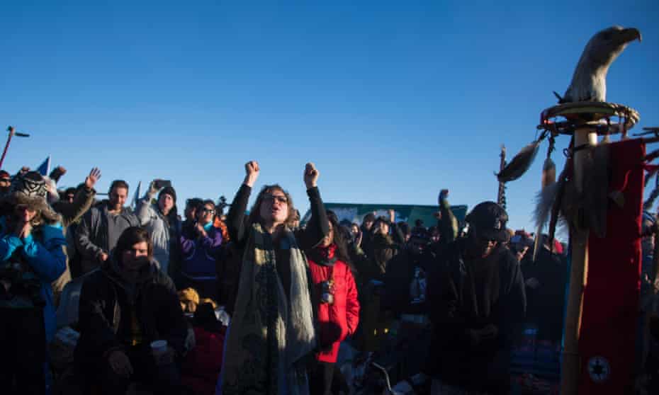 Activists celebrate at Oceti Sakowin Camp on the edge of the Standing Rock Sioux Reservation on December 4, 2016.
