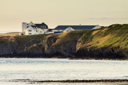 a Clifftop hotel looking over calm water