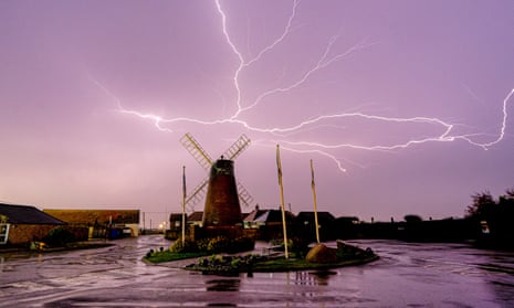 Lightning is seen over Medmerry Mill, Selsey, in West Sussex in the early hours of Thursday as thunderstorms swept the south of England and Wales