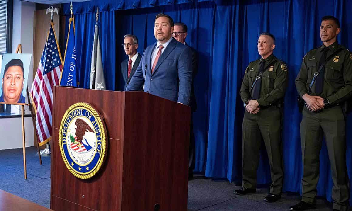 Acting US attorney Joe McNally stands behind a lectern