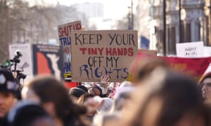 A placard is held aloft during the march in London.
