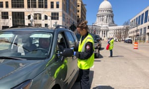 Voters waiting to participate in drive-in voting in Madison, WI. Madison, like Milwaukee, are expected to struggle with voting logistics due to the coronavirus.