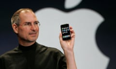 Apple CEO Steve Jobs holds up the new iPhone at MacWorld Conference