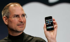 Steve Jobs holds an iPhone